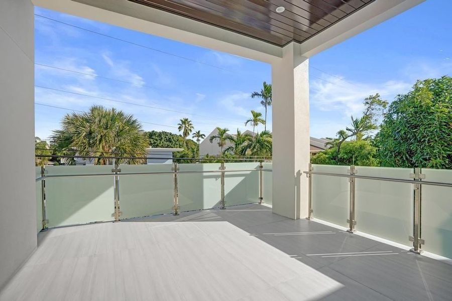 Primary Suite Balcony — Private east-facing retreat overlooking the pool, designed as a true outdoor living space for quiet mornings and relaxed evenings. - Intentionally designed as a private sanctuary perfect for unwinding, entertaining quietly, or starting and ending the day in a peaceful, resort-style setting.