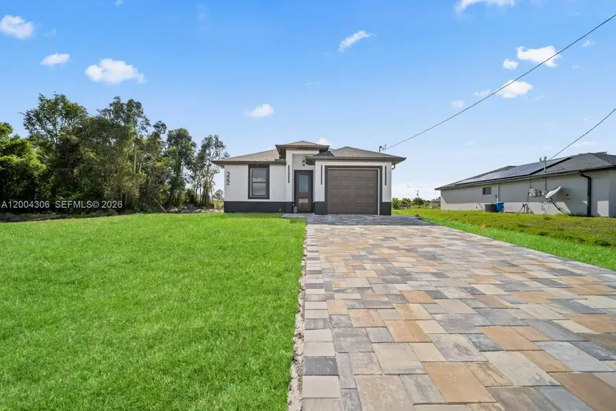 Front exterior of a new home in , Lehigh Acres, FL, highlighting curb appeal (Image 22).
