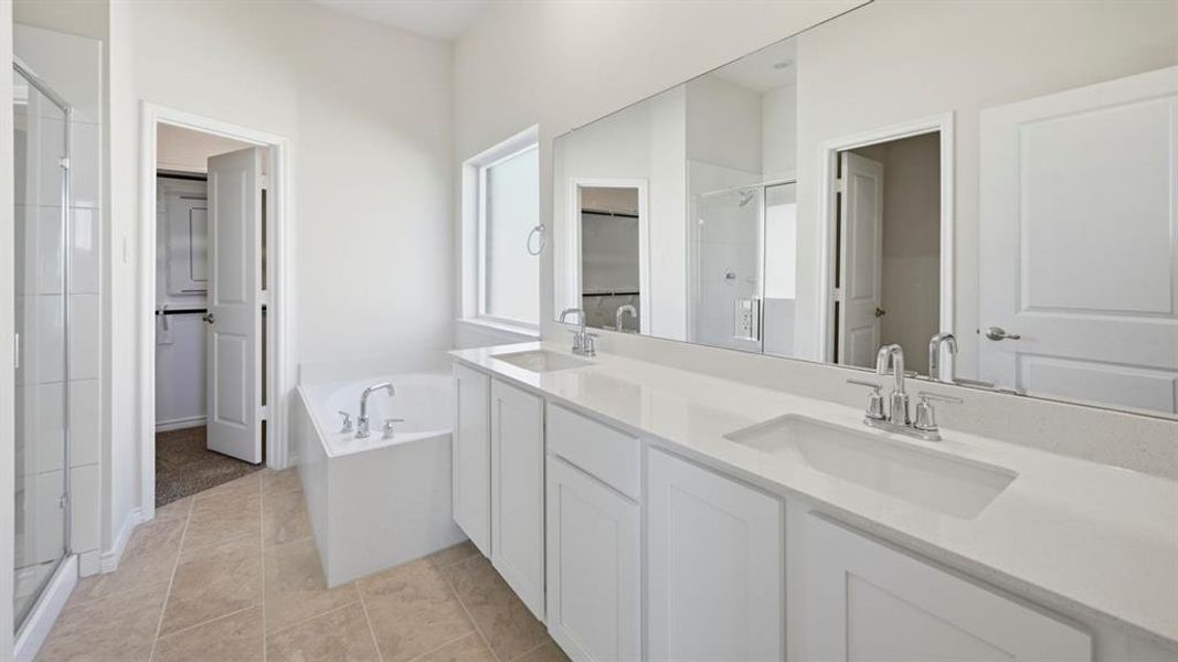 Dual vanity with white cabinetry, integrated sinks, and chrome fixtures