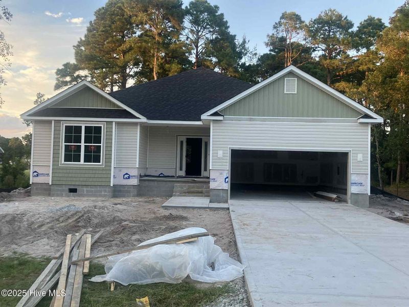 Front exterior of a new home in Fairfield Harbour, New Bern, NC, highlighting curb appeal (Image 1).