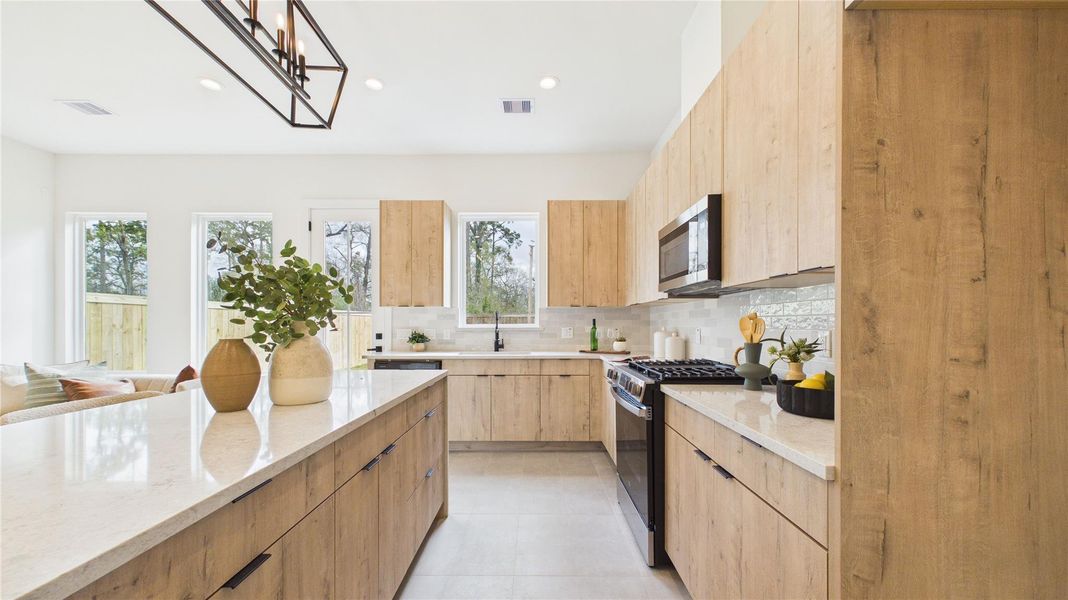Soft-close cabinetry is a sleek arcadia yellow walnut.