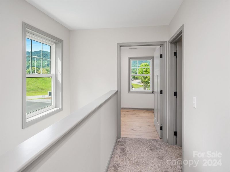 hallway between back of home guest Bedrooms and Primary on Upper level hallway between back of home guest Bedrooms and Primary on Upper level