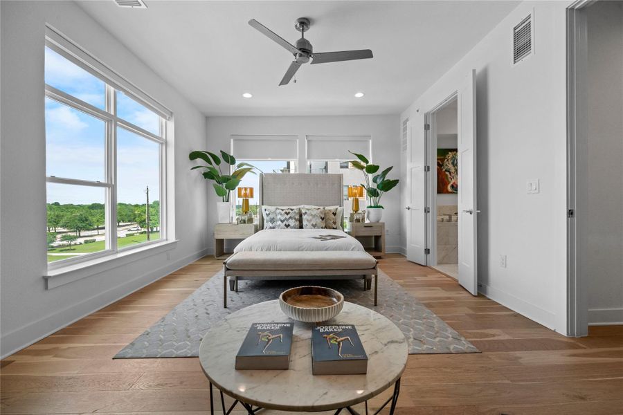 Light wood-finish flooring with expansive windows providing abundant natural light
