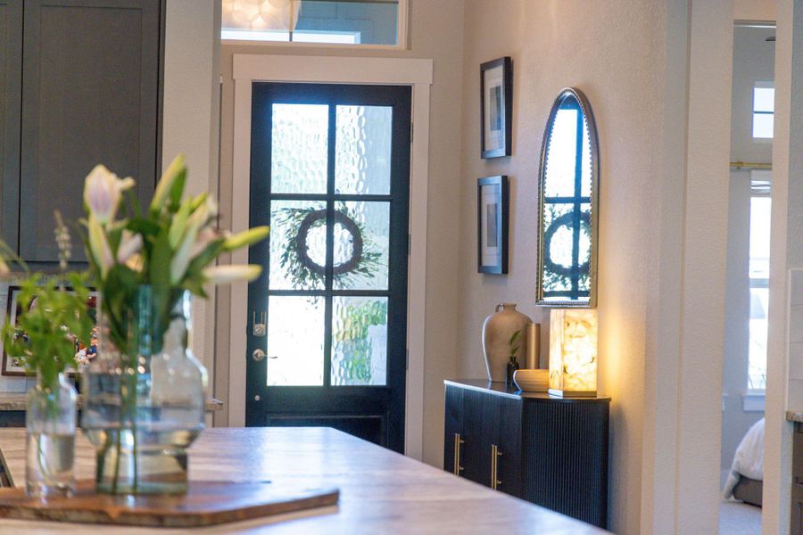 A welcoming entry, with a glass-paneled door, beckons visitors into this charming home.