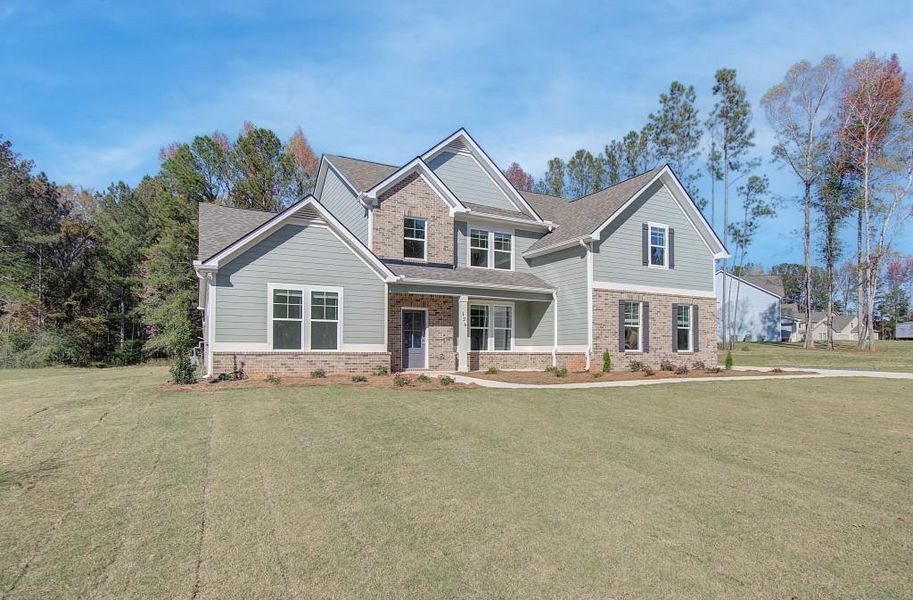 Front exterior of a new home in Saddleridge, Senoia, GA, highlighting curb appeal (Image 2). Front exterior of a new home in Saddleridge, Senoia, GA, highlighting curb appeal (Image 2).