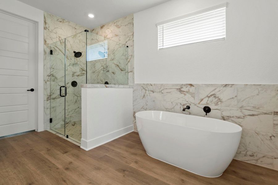 A step-in shower and seperate soaking tub in the master bathroom.