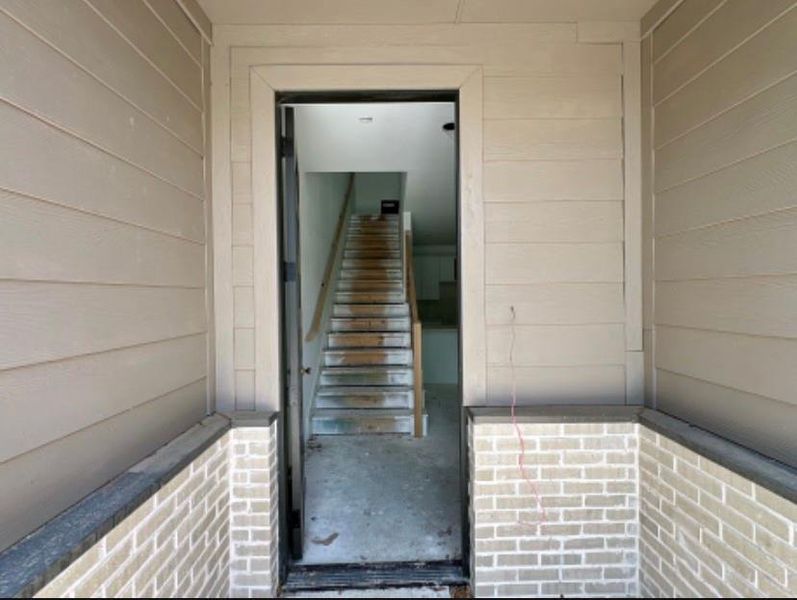 Doorway to property featuring brick siding Doorway to property featuring brick siding