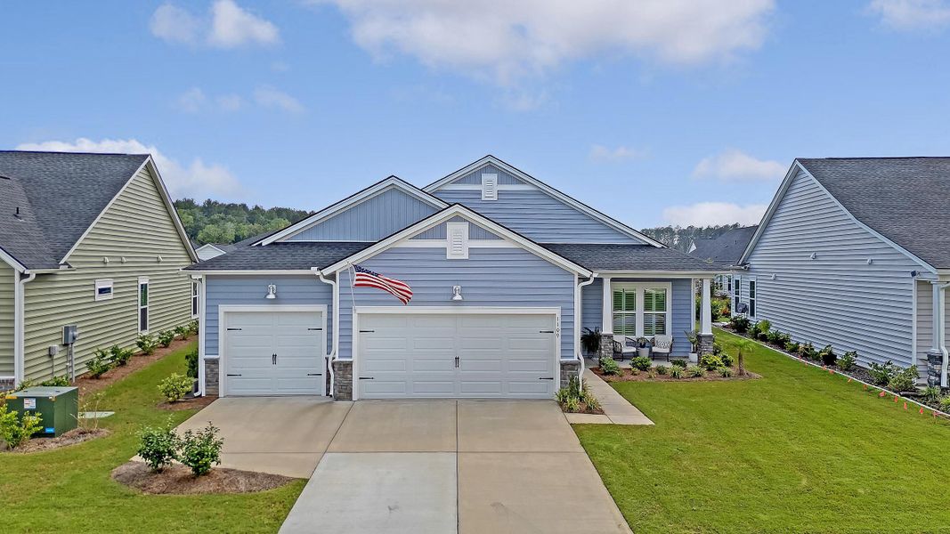 Front exterior of a new home in Horizons at Summers Corner | 55+: The Estates, Summerville, SC, highlighting curb appeal (Image 24).