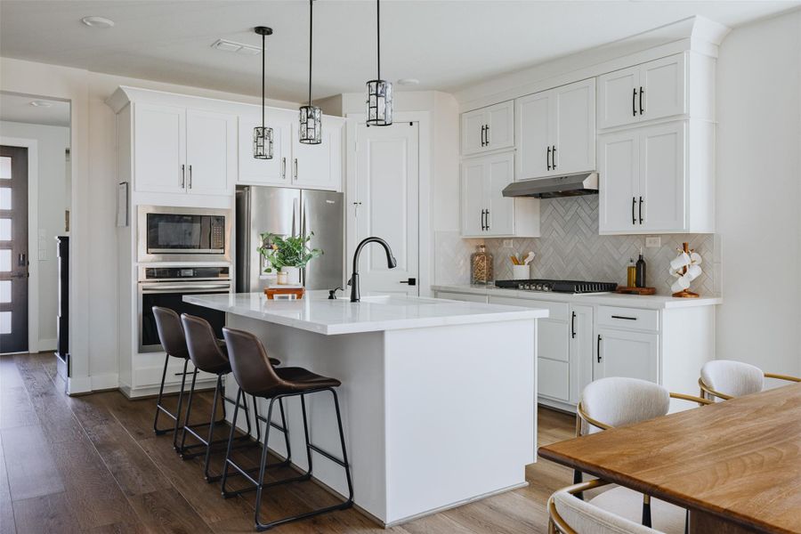 kitchen with white shaker cabinets and quartz counters