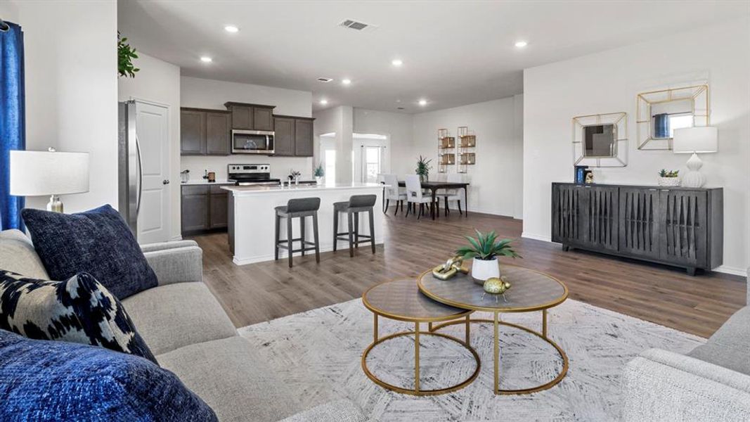 Living room with dark wood-type flooring and recessed lighting