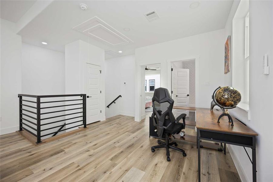 The stairs from the second floor lead to this gorgeous open and large flex space that could be a second family room, home gym, home office, or gameroom.