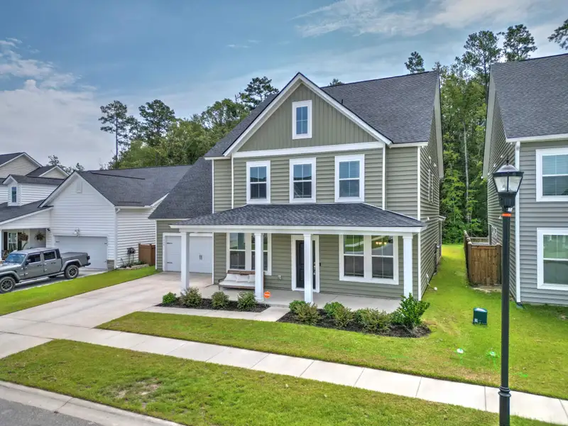 Front exterior of a new home in Sweetgrass at Summers Corner, Summerville, SC, highlighting curb appeal (Image 1). Front exterior of a new home in Sweetgrass at Summers Corner, Summerville, SC, highlighting curb appeal (Image 1).