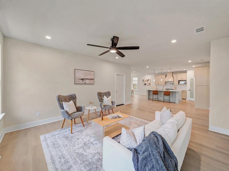 Living room featuring light hardwood / wood-style floors and ceiling fan