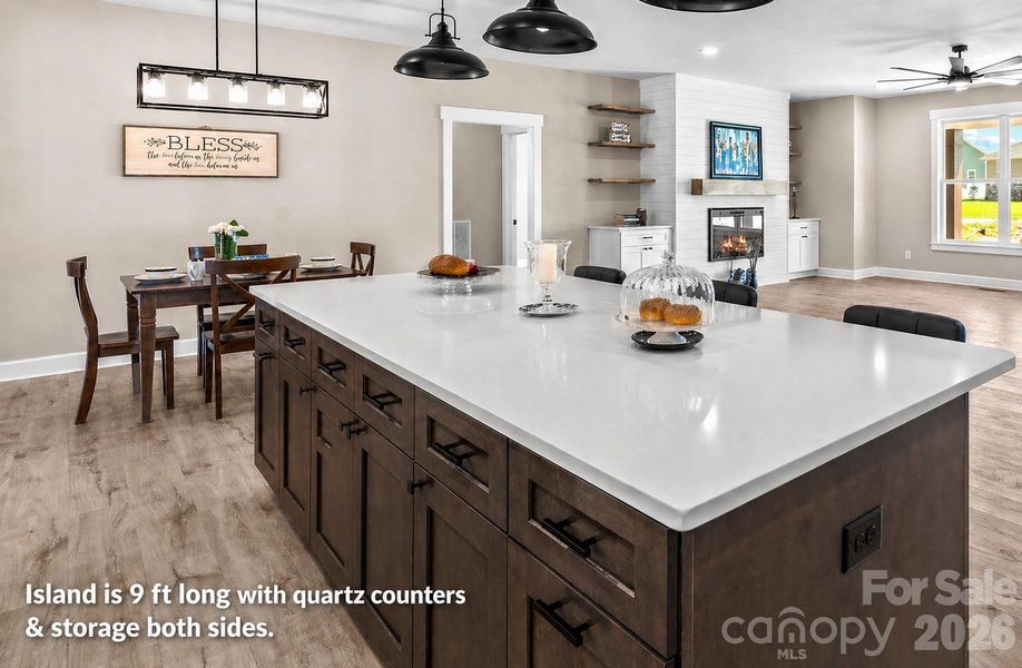 Island is 9 ft with quartz counters & storage both sides.