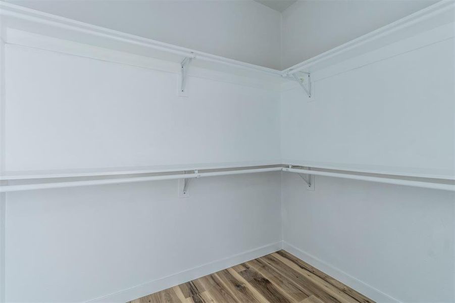 Spacious closet with wood finished floors Spacious closet with wood finished floors