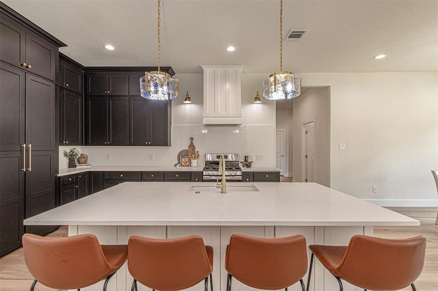 Expansive kitchen island with a built-in sink and gold-finish faucet