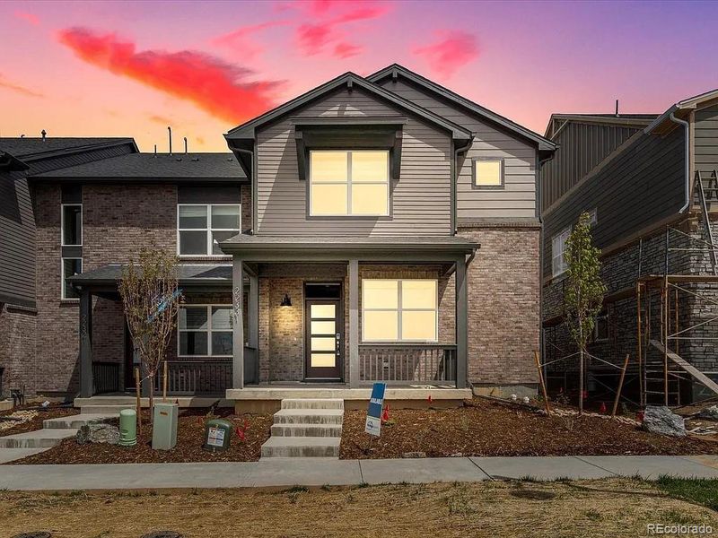 Front exterior of a new home in Painted Prairie, Aurora, CO, highlighting curb appeal (Image 1).
