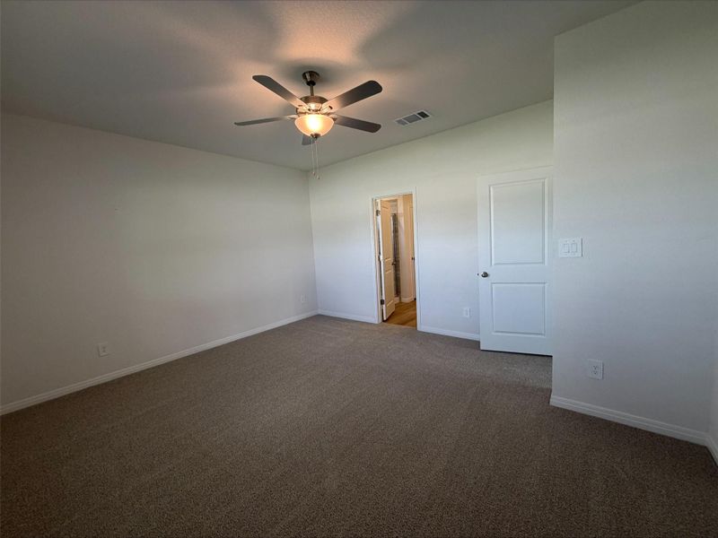 Unfurnished room featuring carpet and ceiling fan Unfurnished room featuring carpet and ceiling fan