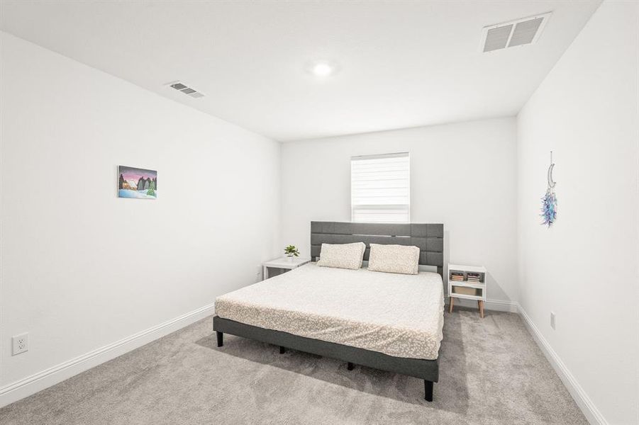 Bedroom with light carpet