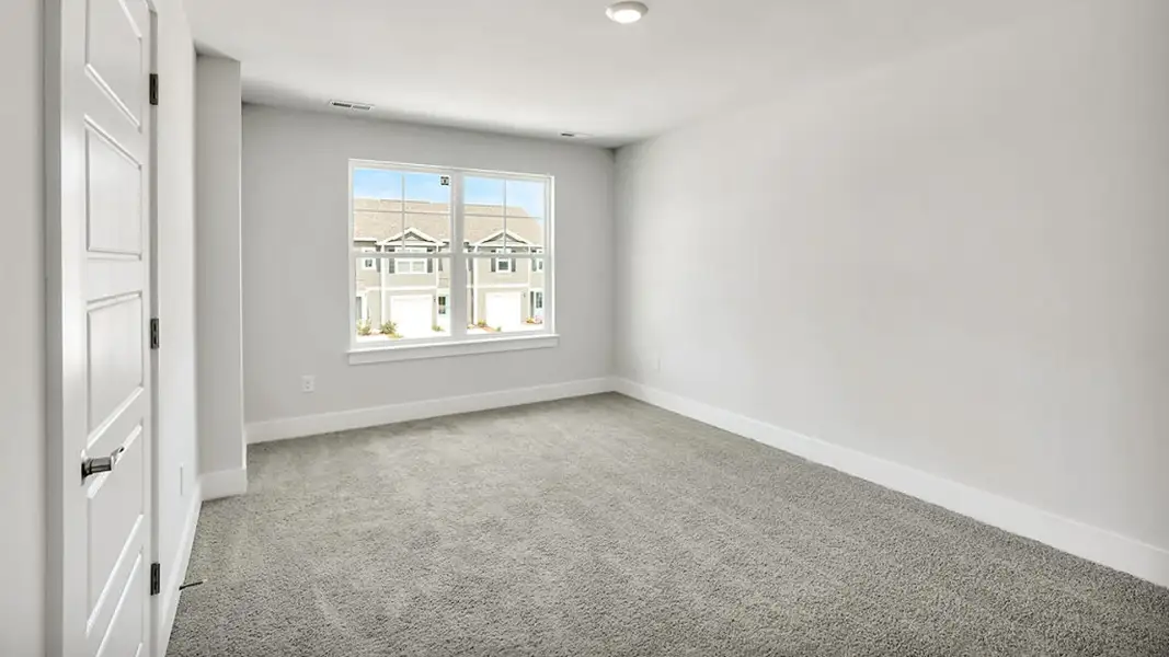 Spacious, unfurnished interior of a new home in The Cove at Indigo Preserve Townhomes, Leland (Image 12).