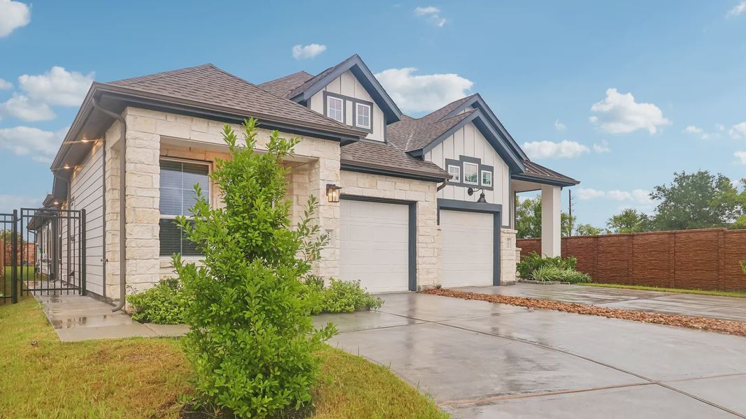 Front exterior of a new home in Meridiana Townhomes, Manvel, TX, highlighting curb appeal (Image 26).