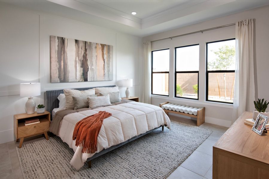 Primary suite with coffered ceiling and decorative feature wall Primary suite with coffered ceiling and decorative feature wall