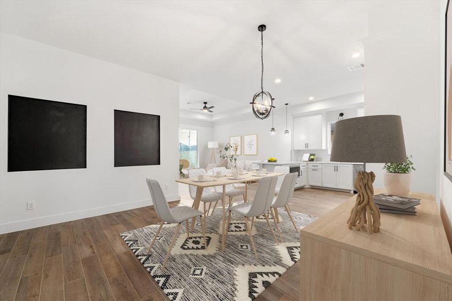 The dining area features a charming accent wall with black details and is adorned with a stylish chandelier. (Virtually staged)