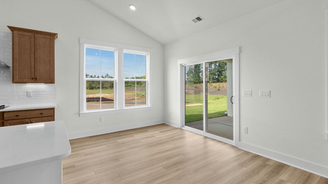 Bright dining area with backyard access at Chestnut Farms by DRB Homes