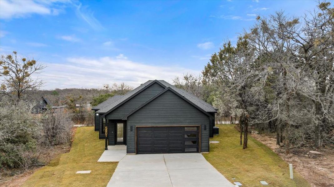 Front exterior of a new home in , Granbury, TX, highlighting curb appeal (Image 2). Front exterior of a new home in , Granbury, TX, highlighting curb appeal (Image 2).