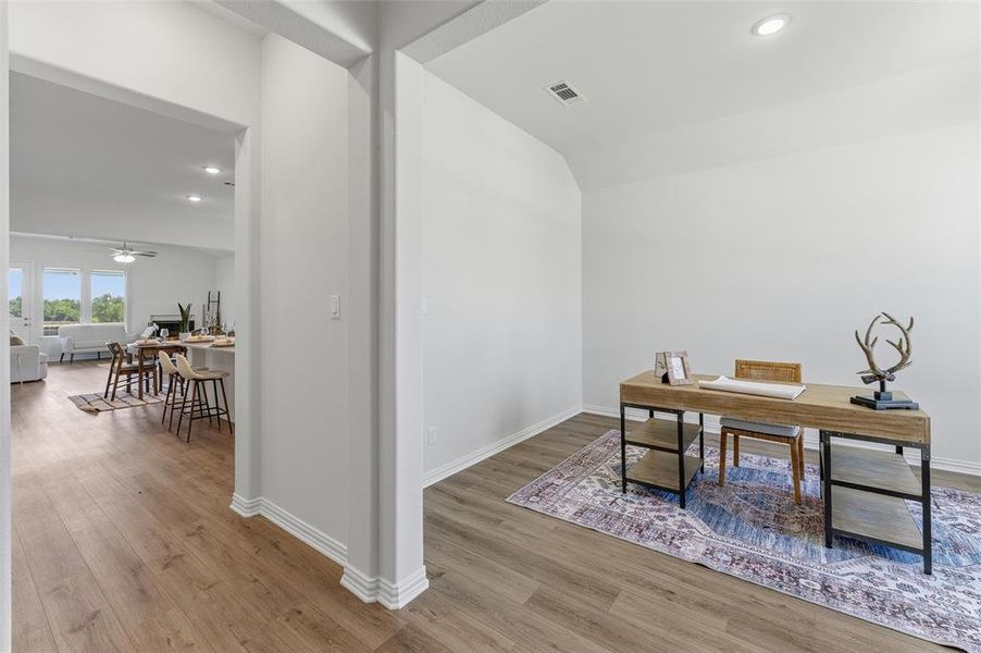 Entryway leading to an open-concept living area with wood-finish flooring throughout
