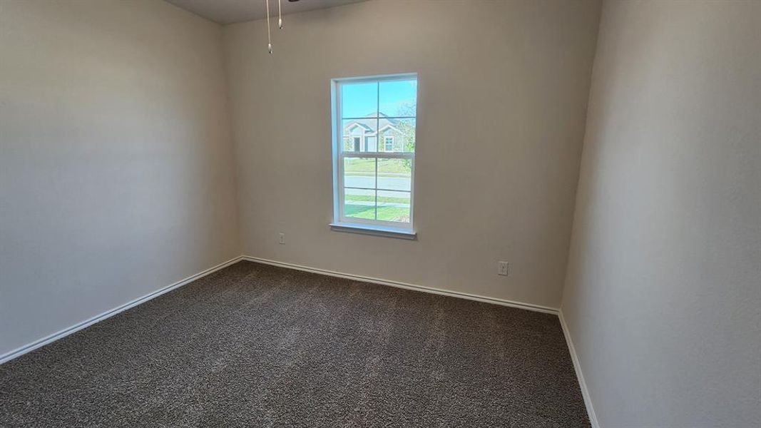Carpeted room featuring a white-framed window, neutral painted walls, white baseboards, and a ceiling fan Carpeted room featuring a white-framed window, neutral painted walls, white baseboards, and a ceiling fan