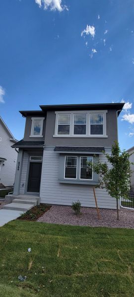 Front exterior of a new home in Revel Crossing at Wolf Ranch – The Ascent Collection, Colorado Springs, CO, highlighting curb appeal (Image 1). Front exterior of a new home in Revel Crossing at Wolf Ranch – The Ascent Collection, Colorado Springs, CO, highlighting curb appeal (Image 1).