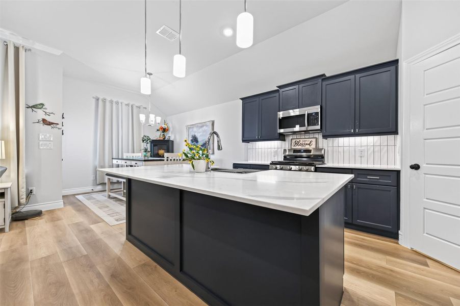 This kitchen features a sleek, durable quartz countertop that serves as an excellent focal point for the room. If you are hosting larger gatherings and require additional seating, you can easily pull up extra chairs to the island to accommodate more guests comfortably while enjoying the open-concept layout. This kitchen features a sleek, durable quartz countertop that serves as an excellent focal point for the room. If you are hosting larger gatherings and require additional seating, you can easily pull up extra chairs to the island to accommodate more guests comfortably while enjoying the open-concept layout.