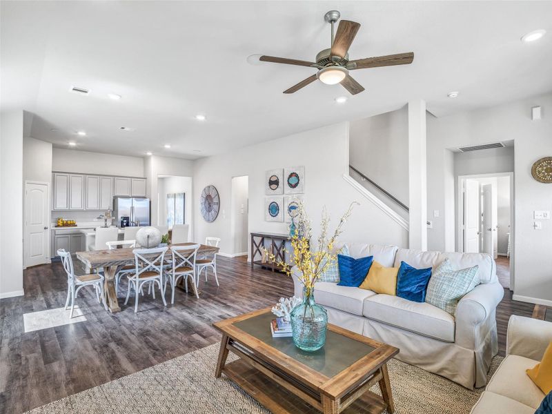 Welcome family and guests to your charming living room! With its high ceilings, recessed lighting, ceiling fan, custom paint, beautiful flooring, and large windows that let in abundant natural light, this room is perfect for gatherings. Sample photo of completed home with similar floor plan. Actual colors and selections may vary. Welcome family and guests to your charming living room! With its high ceilings, recessed lighting, ceiling fan, custom paint, beautiful flooring, and large windows that let in abundant natural light, this room is perfect for gatherings. Sample photo of completed home with similar floor plan. Actual colors and selections may vary.