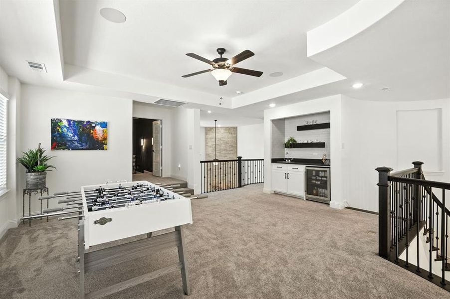 Large game room or loft area with a wet bar.