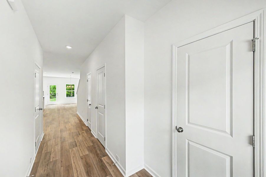 Entry foyer with a coat closet, powder room, and storage closet.