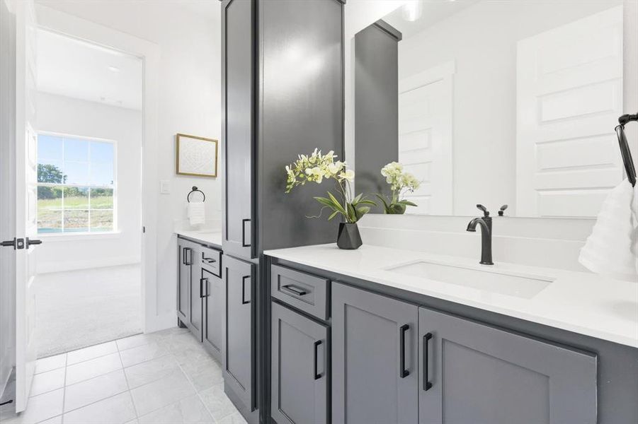 Jack and jill bathroom with dual vanities/sinks, linen storage and water closet with tub/shower combo