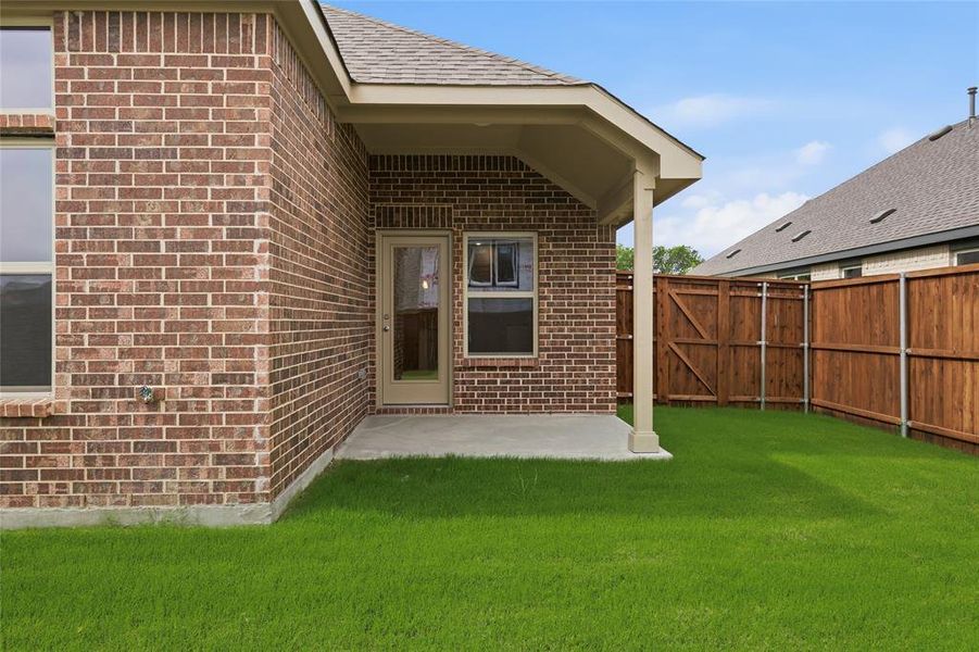 Exterior brick construction with a covered patio and concrete slab Exterior brick construction with a covered patio and concrete slab
