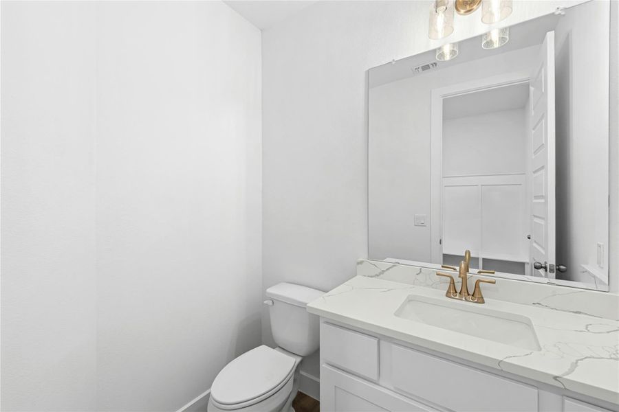 Half bath with vanity and toilet