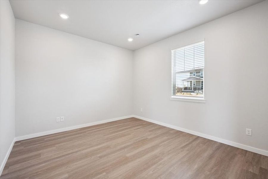 A room with a wood floor and a window.