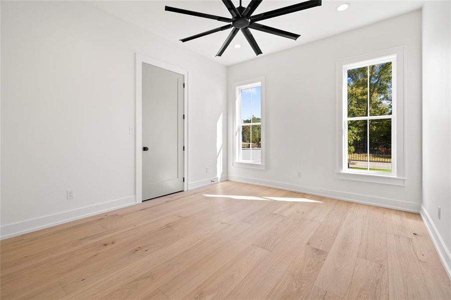 Spare room with ceiling fan, light wood-style floors, and recessed lighting