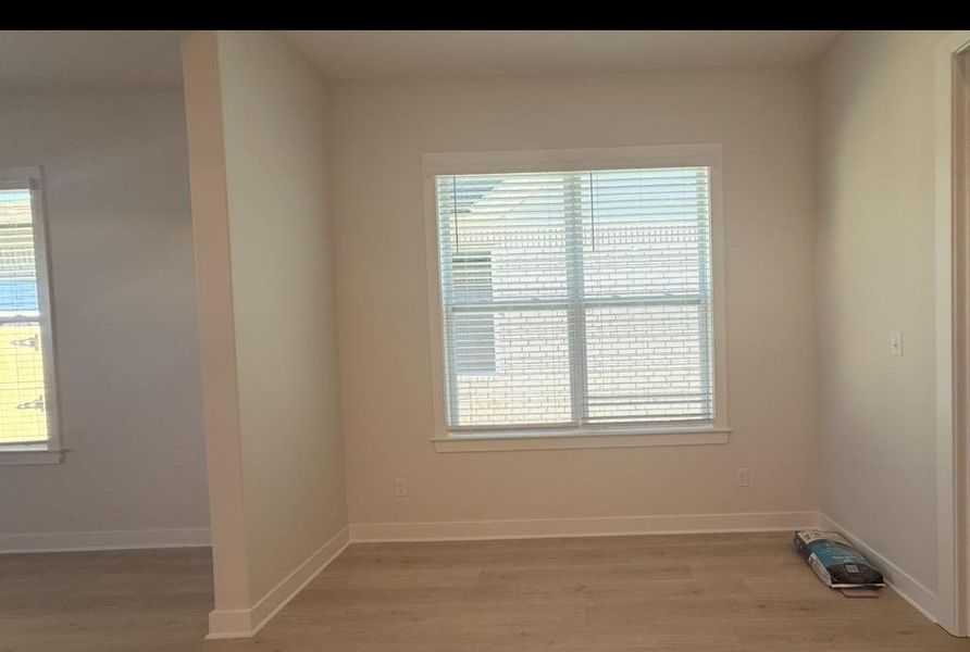 Unfurnished room featuring light wood-type flooring and baseboards