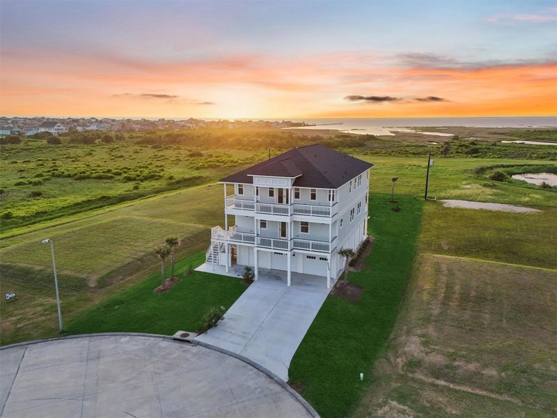 Twilight aerial of the property highlights two full levels of water-facing decks and unmatched privacy backing to protected green space. Twilight aerial of the property highlights two full levels of water-facing decks and unmatched privacy backing to protected green space.