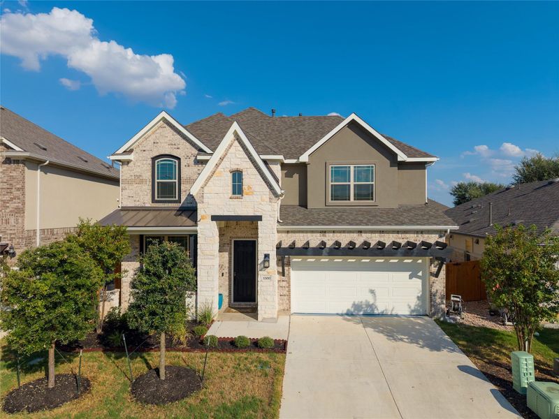 Multi-textured masonry siding and an elegant gabled roofline define this classic two-story exterior. Multi-textured masonry siding and an elegant gabled roofline define this classic two-story exterior.