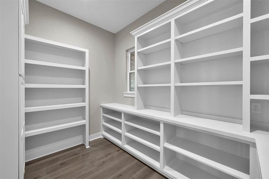 Walk-in pantry with ample shelf's for storage and electrical outlets for appliances.