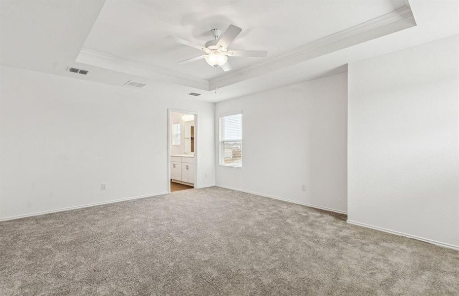 Spacious owner's suite highlighted by large windows and an exquisite tray ceiling *Real home pictured Spacious owner's suite highlighted by large windows and an exquisite tray ceiling *Real home pictured