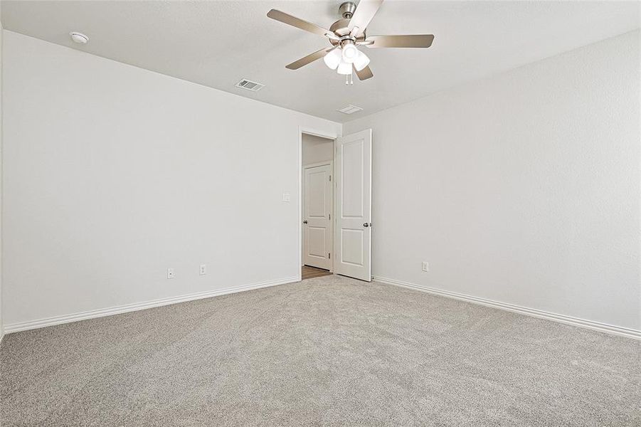 Spare room with light carpet and ceiling fan