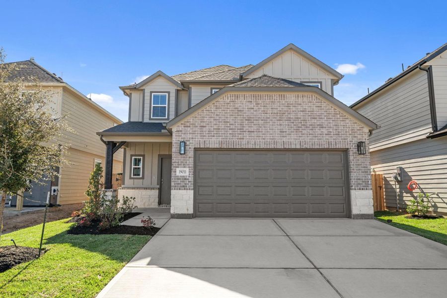 Front exterior of a new home in Grand Oaks Village, Houston, TX, highlighting curb appeal (Image 18).