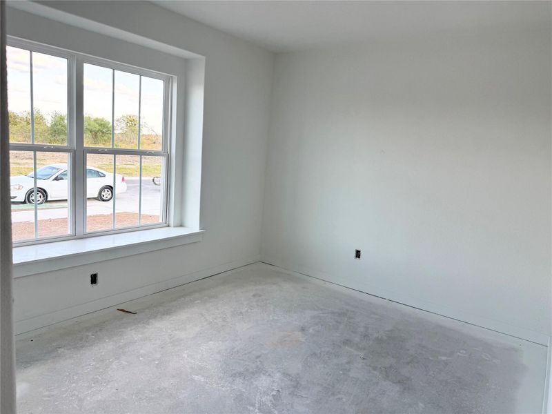 Empty room with unfinished concrete flooring