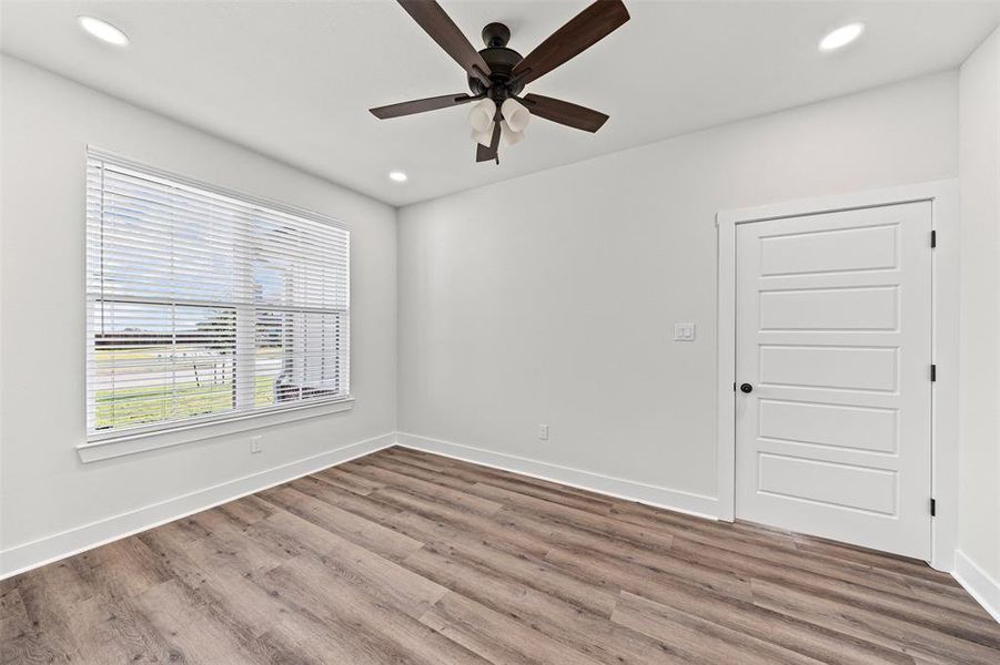 Unfurnished bedroom featuring recessed lighting, wood finished floors, and a ceiling fan Unfurnished bedroom featuring recessed lighting, wood finished floors, and a ceiling fan
